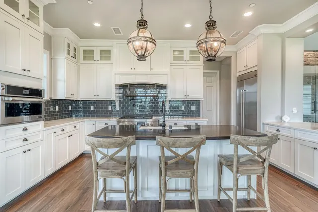 an empty room with windows and a ceiling fan