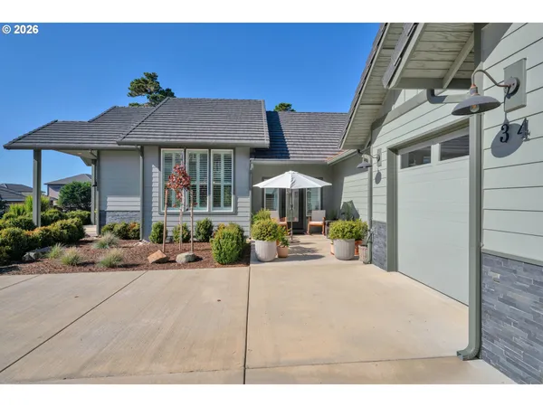 a view of a house with backyard porch and sitting area