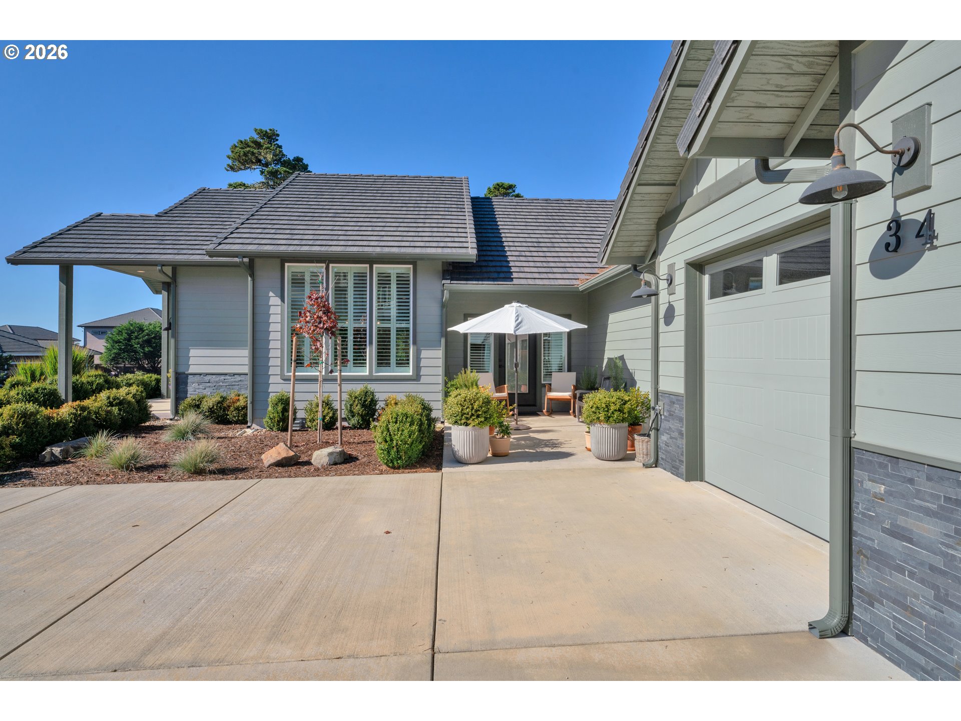 34 Bonnett Way Florence, OR 97439 - Photo 12 of 48 a view of a house with backyard porch and sitting area