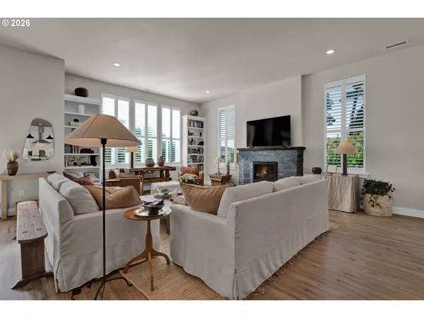 a living room with furniture a fireplace and a flat screen tv
