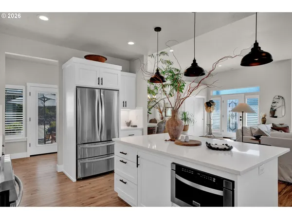 a kitchen with stainless steel appliances granite countertop a refrigerator a sink and a stove