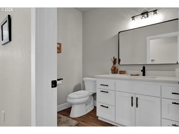 a bathroom with a sink a toilet and mirror