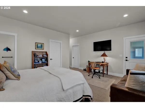 a bedroom with furniture and a flat screen tv