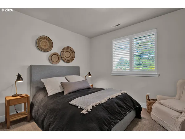 a bedroom with a bed and a chair