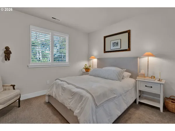 a bedroom with a bed and a night stand