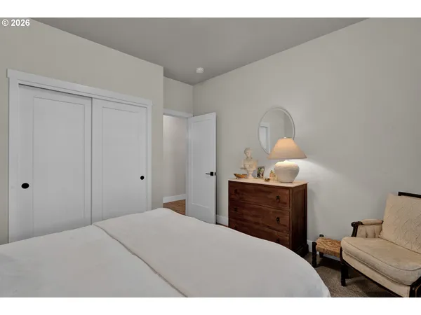 a bedroom with a bed and cabinet