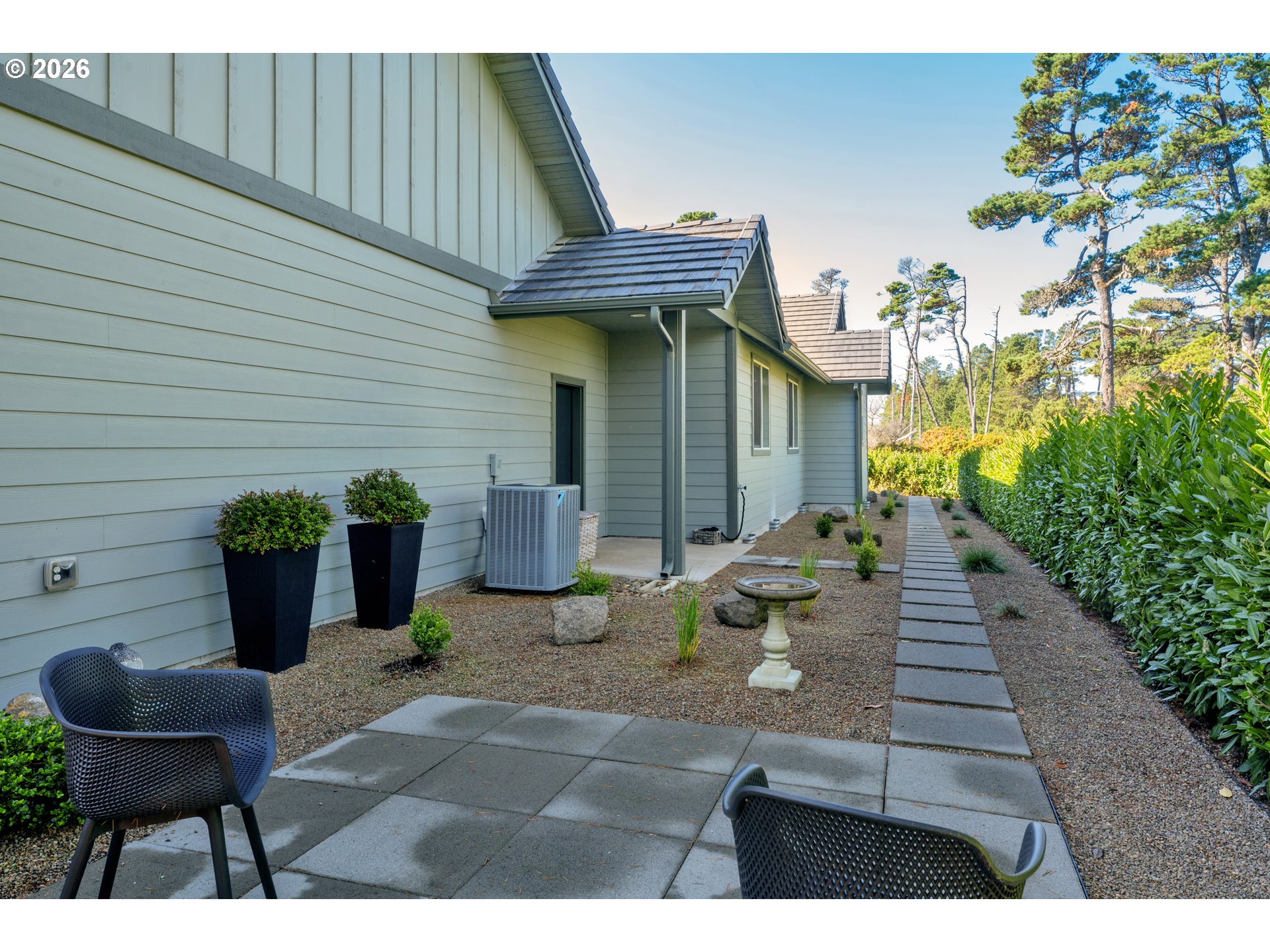 34 Bonnett Way Florence, OR 97439 - Photo 39 of 48 a view of a patio with couches table and chairs and potted plants