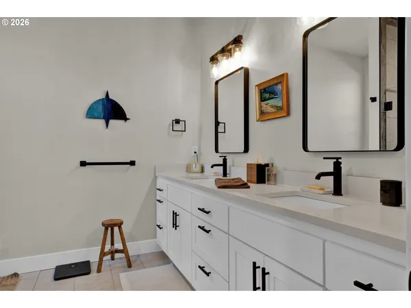a bathroom with a double vanity sink mirror and