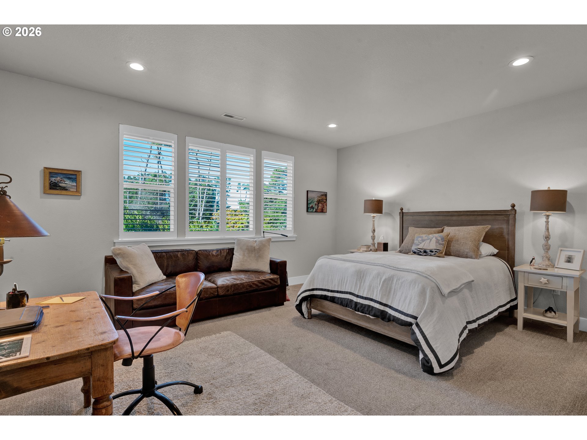 34 Bonnett Way Florence, OR 97439 - Photo 5 of 48 a spacious bedroom with a bed a couch and a potted plant