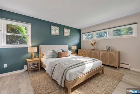 a bedroom with a bed and a night stand