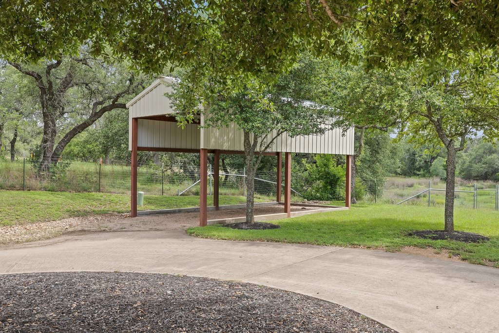 12135 Fitzhugh Road Austin, TX 78736 - Photo 25 of 30 a view of a white house with a big yard and large trees