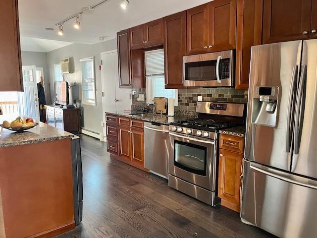 87 Bartlett Place Brooklyn, NY 11229 - Photo 12 of 20 a kitchen with stainless steel appliances a stove a refrigerator a sink a stove with wooden floors