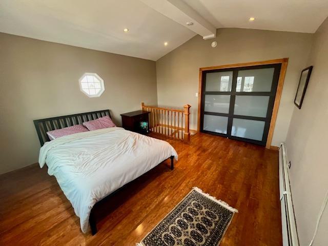 87 Bartlett Place Brooklyn, NY 11229 - Photo 19 of 20 a bedroom with a bed and wooden floor