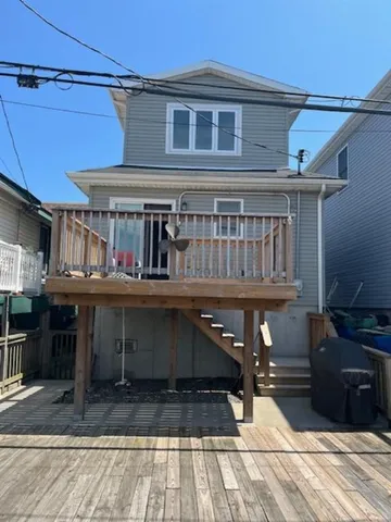 a view of a house with wooden deck