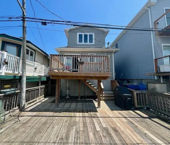 a view of a house with wooden deck