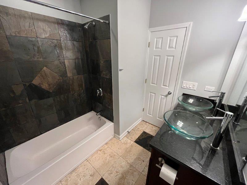 2249 South Bell Avenue, Unit 1R Chicago, IL 60608 - Photo 11 of 11 a bathroom with a sink a toilet and shower