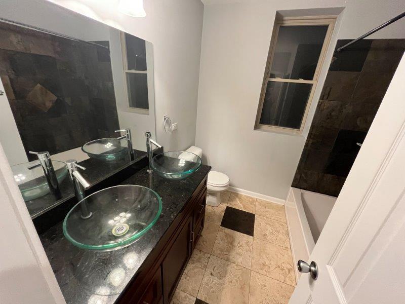 2249 South Bell Avenue, Unit 1R Chicago, IL 60608 - Photo 10 of 11 a bathroom with a sink and mirror