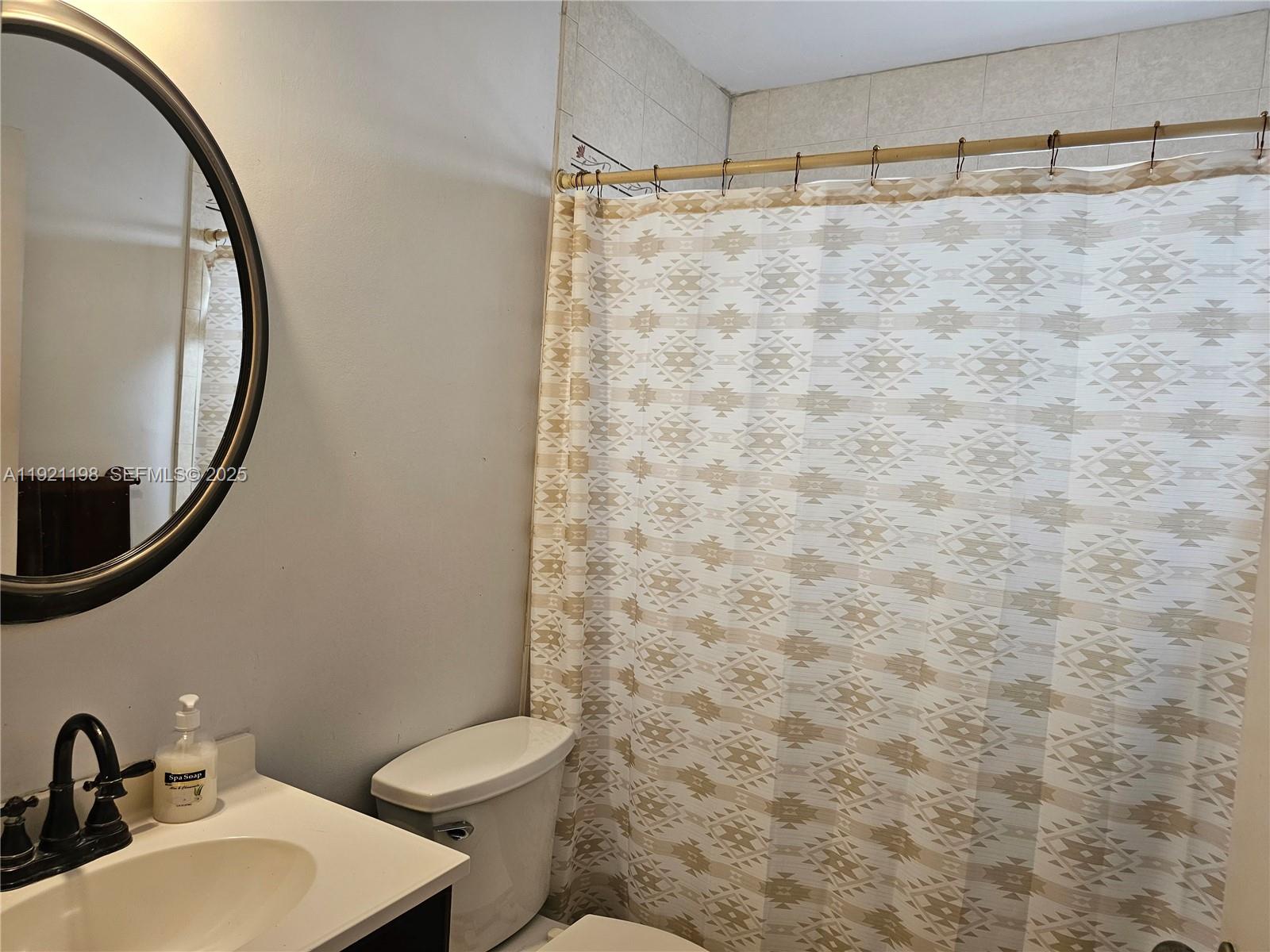 10816 Southwest 75th Street Miami, FL 33173 - Photo 14 of 20 a bathroom with a sink a toilet and a mirror