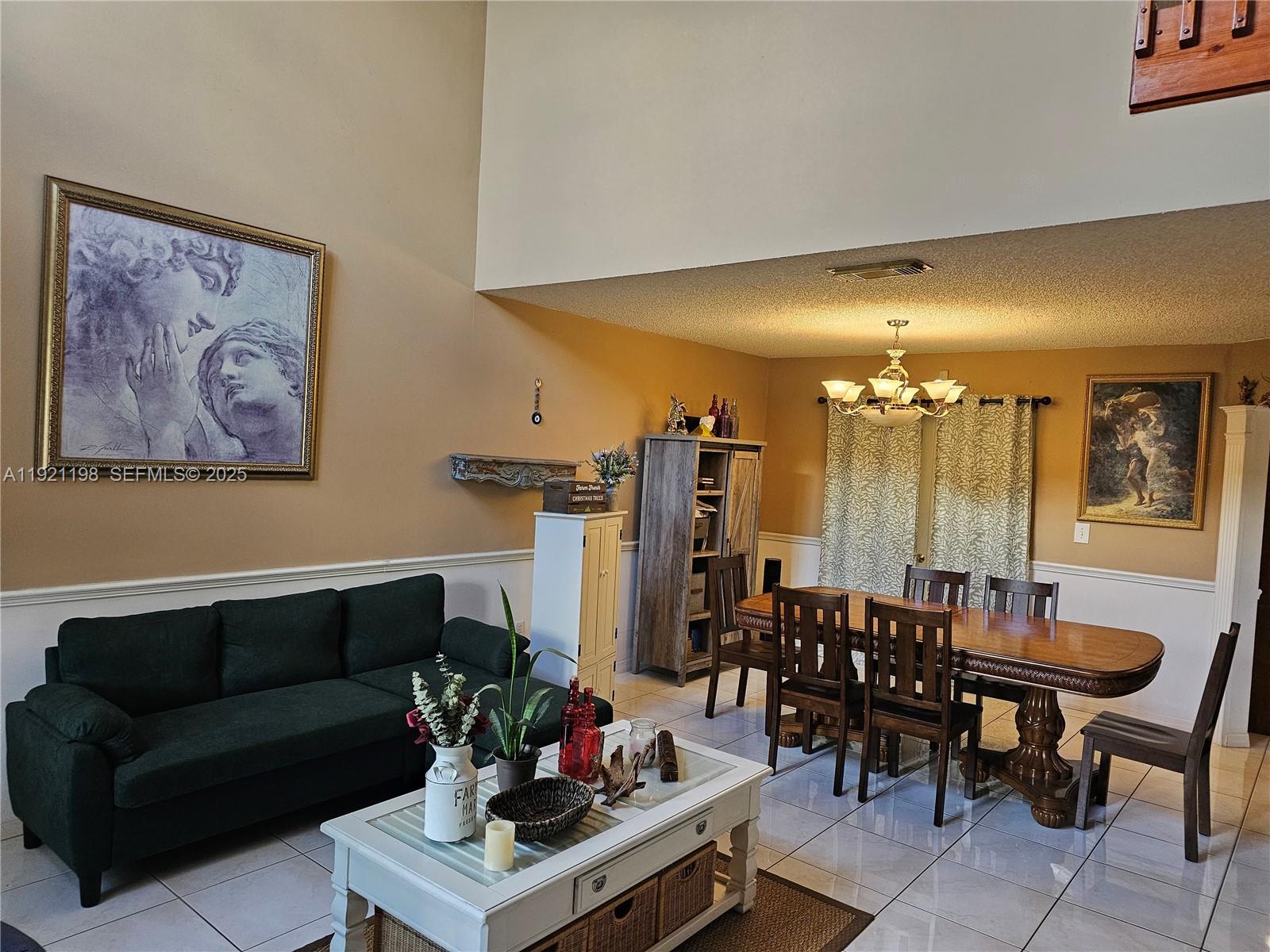 10816 Southwest 75th Street Miami, FL 33173 - Photo 3 of 20 a living room with furniture and a dining table