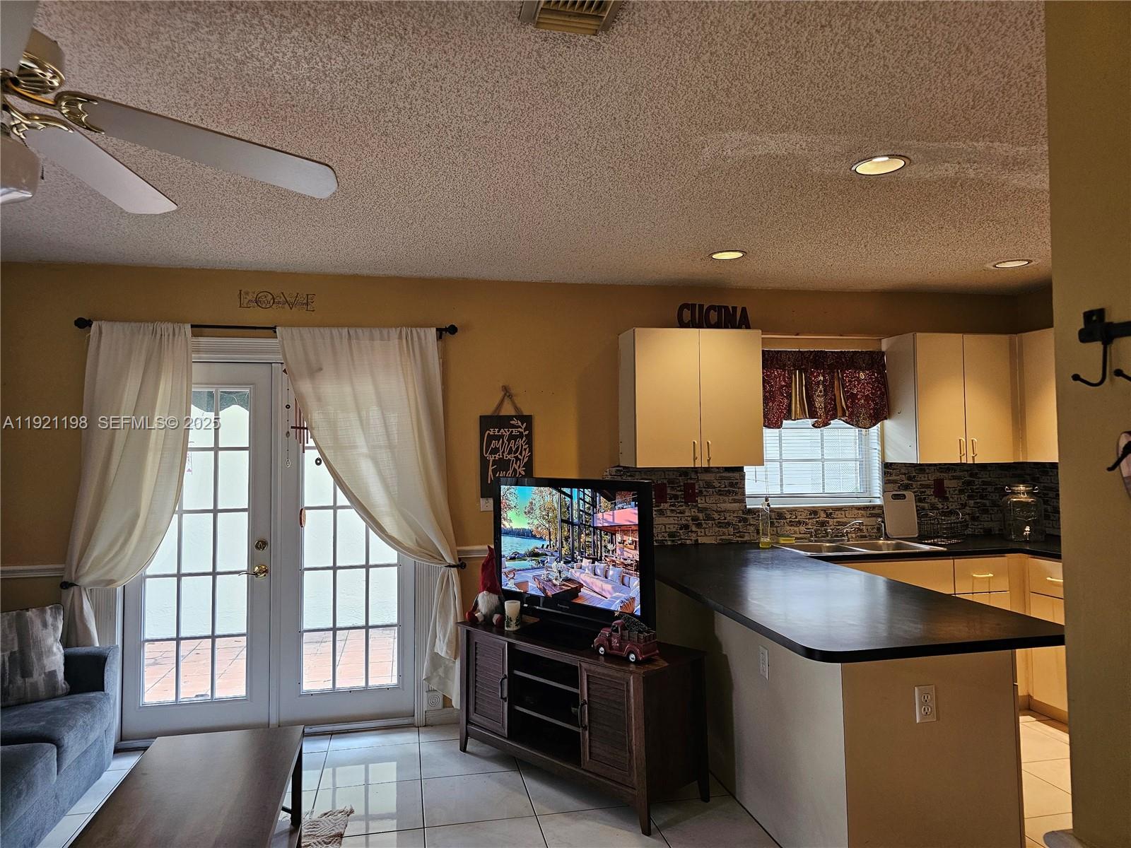 10816 Southwest 75th Street Miami, FL 33173 - Photo 8 of 20 a kitchen with stainless steel appliances granite countertop a stove a sink and a refrigerator