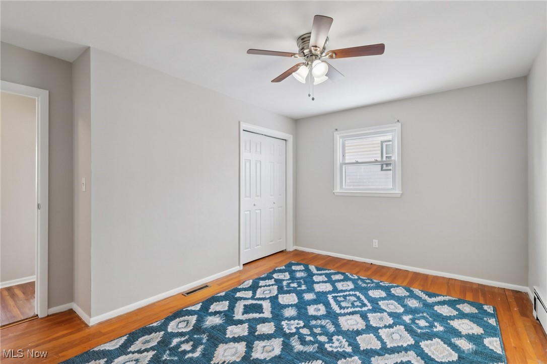 611 Wilson Street Struthers, OH 44471 - Photo 29 of 44 Unfurnished bedroom with light wood-style floors, a closet, ceiling fan, and a baseboard radiator