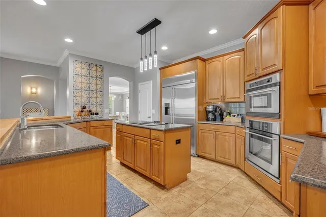 a large kitchen with granite countertop a sink and dishwasher with a large kitchen island