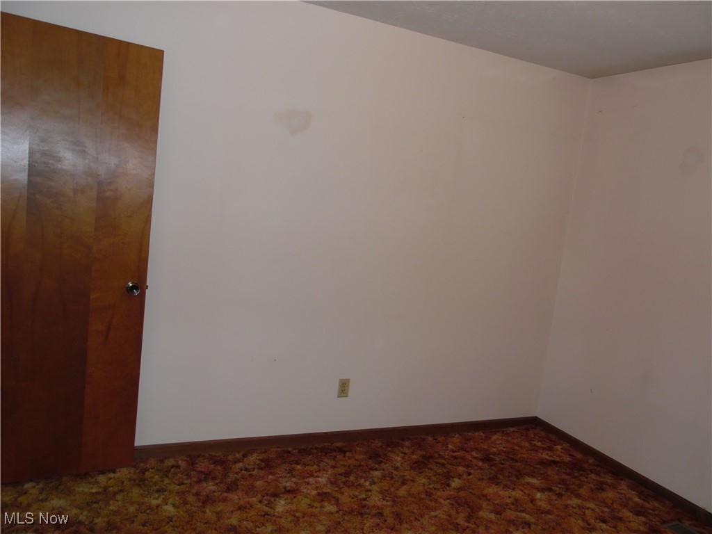 2800 Tick Ridge Road Lower Salem, OH 45745 - Photo 13 of 28 Unfurnished room with baseboards and dark carpet