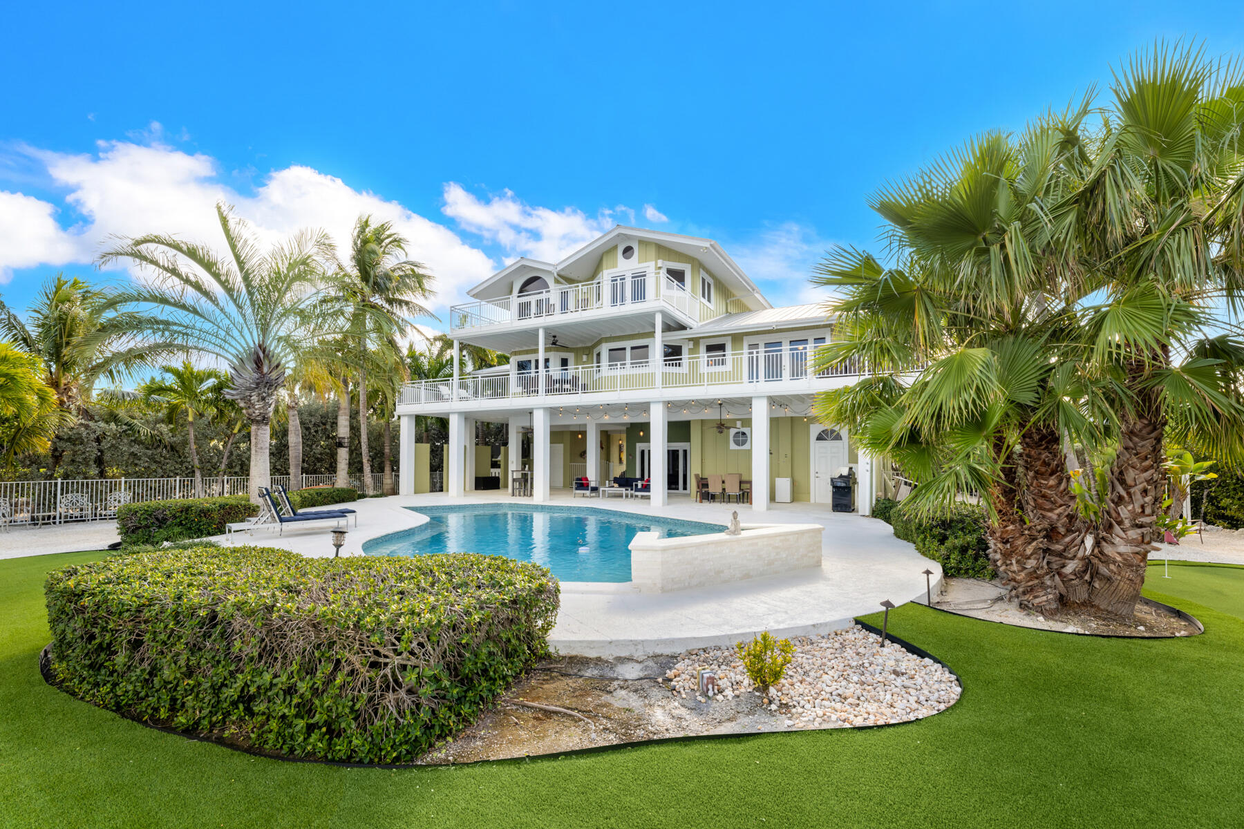 51 Mutiny Place Key Largo, FL 33037 - Photo 4 of 75 a front view of a house with a garden