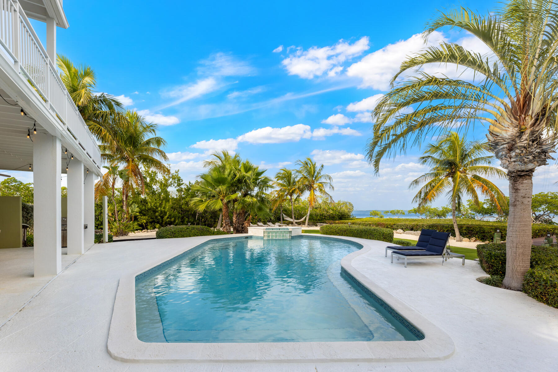 51 Mutiny Place Key Largo, FL 33037 - Photo 45 of 75 a view of a swimming pool with a lounge chair