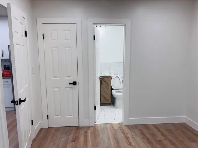a view of a livingroom with wooden floor and closet