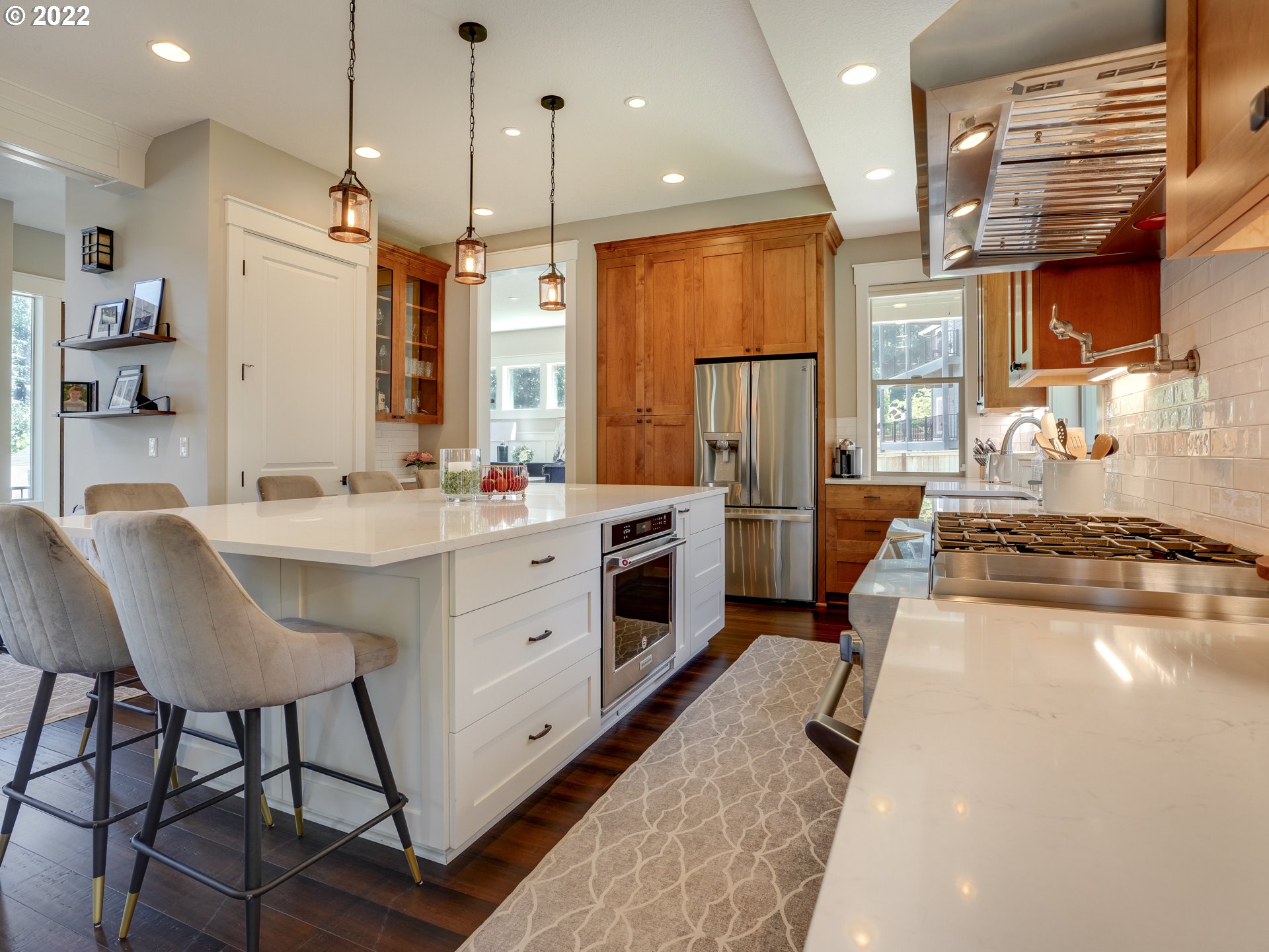 701 South 19th Place Ridgefield, WA 98642 - Photo 6 of 32 a large kitchen with stainless steel appliances kitchen island granite countertop a stove a sink and a refrigerator