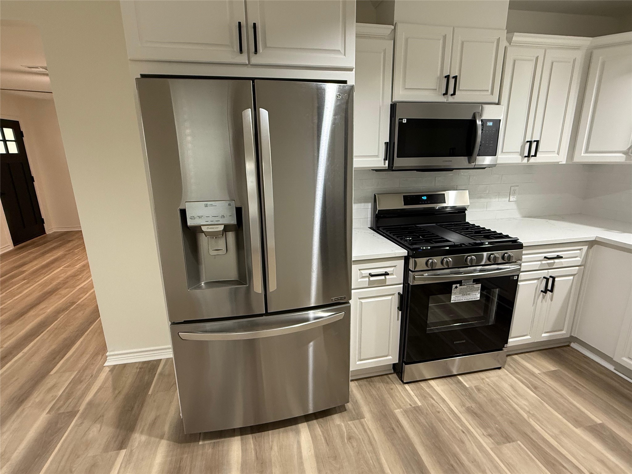 6210 Delany Road Hitchcock, TX 77563 - Photo 6 of 12 a kitchen with appliances a refrigerator and cabinets