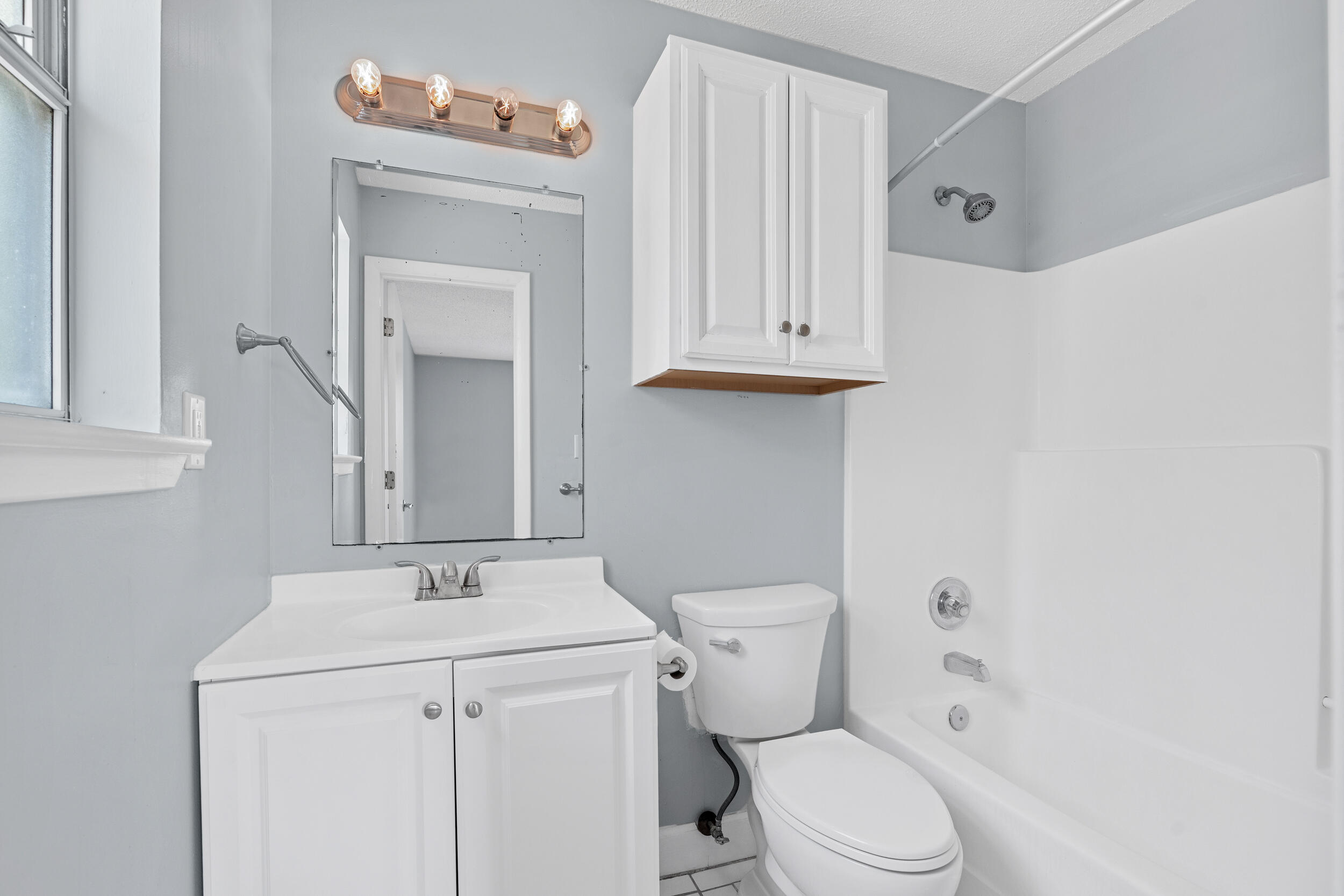 78 Walnut Street Santa Rosa Beach, FL 32459 - Photo 14 of 34 a bathroom with a sink a toilet and a mirror