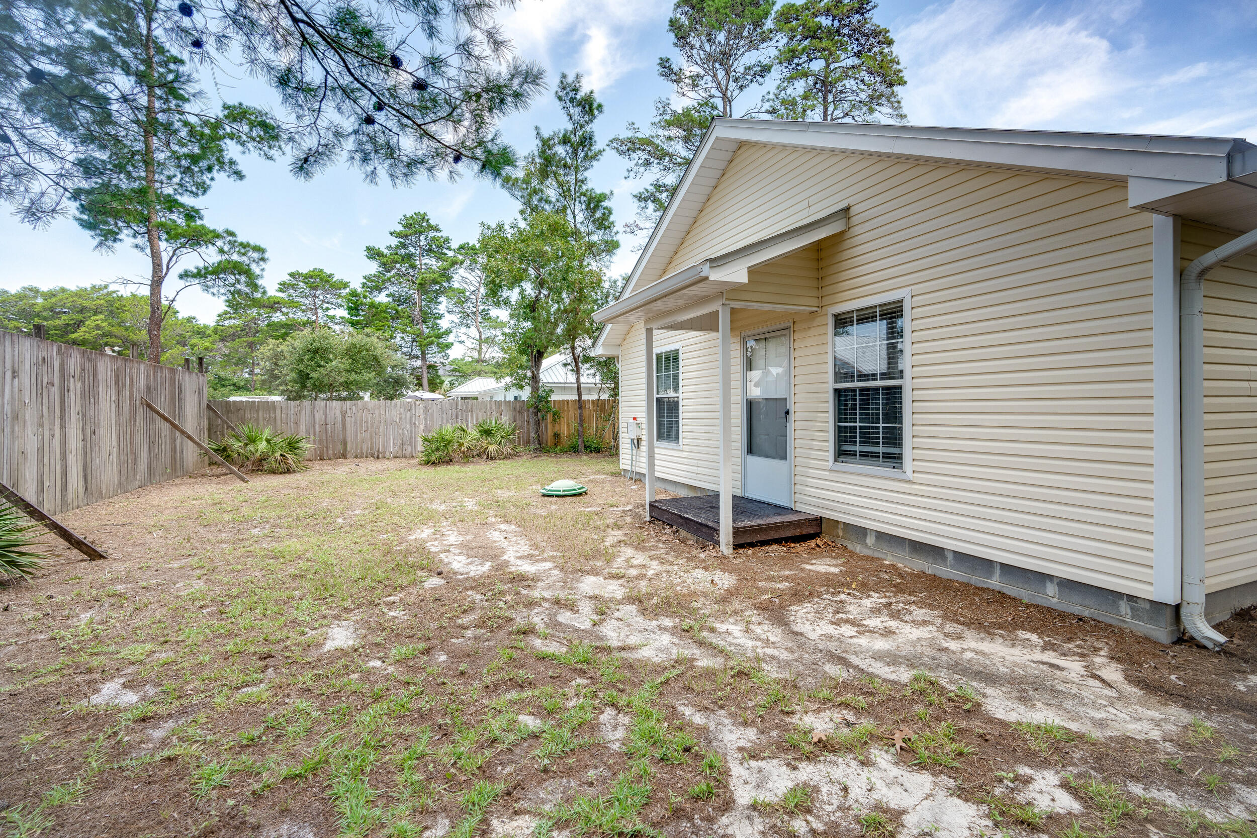 78 Walnut Street Santa Rosa Beach, FL 32459 - Photo 23 of 34 a backyard of a house with a tree
