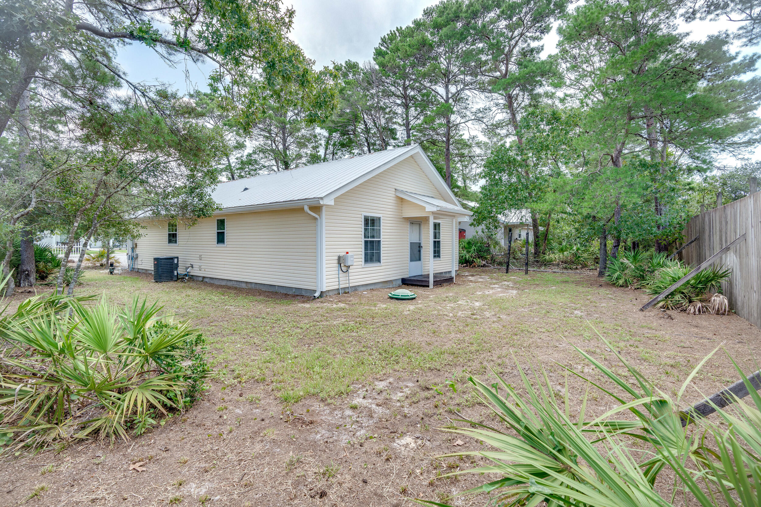 78 Walnut Street Santa Rosa Beach, FL 32459 - Photo 25 of 34 a view of an house with backyard space and garden