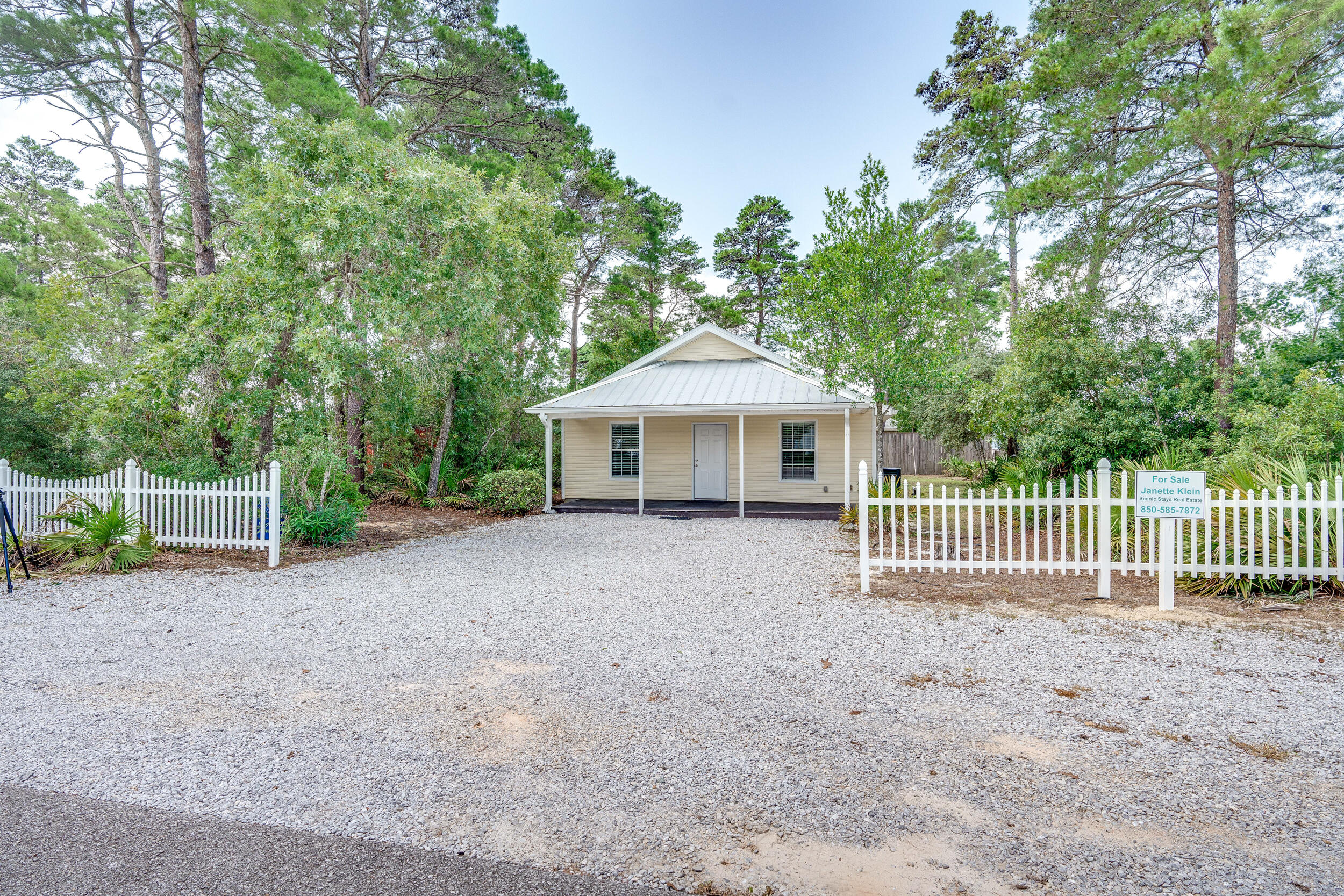 78 Walnut Street Santa Rosa Beach, FL 32459 - Photo 31 of 34 a front view of a house with a garden