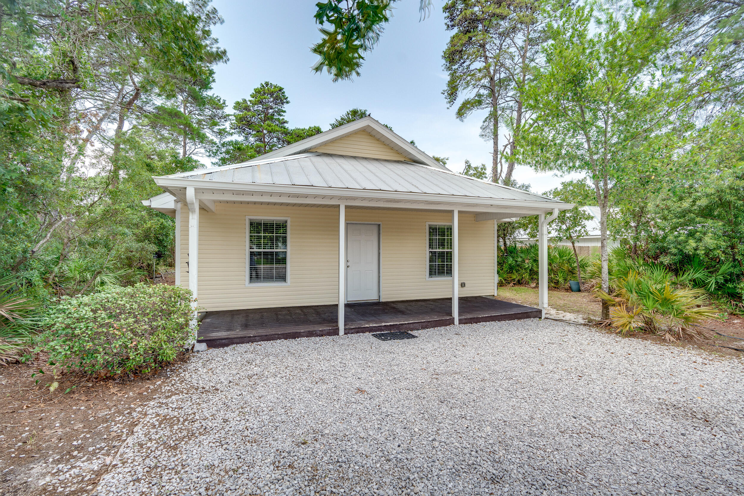 78 Walnut Street Santa Rosa Beach, FL 32459 - Photo 32 of 34 front view of a house with a yard and potted plants