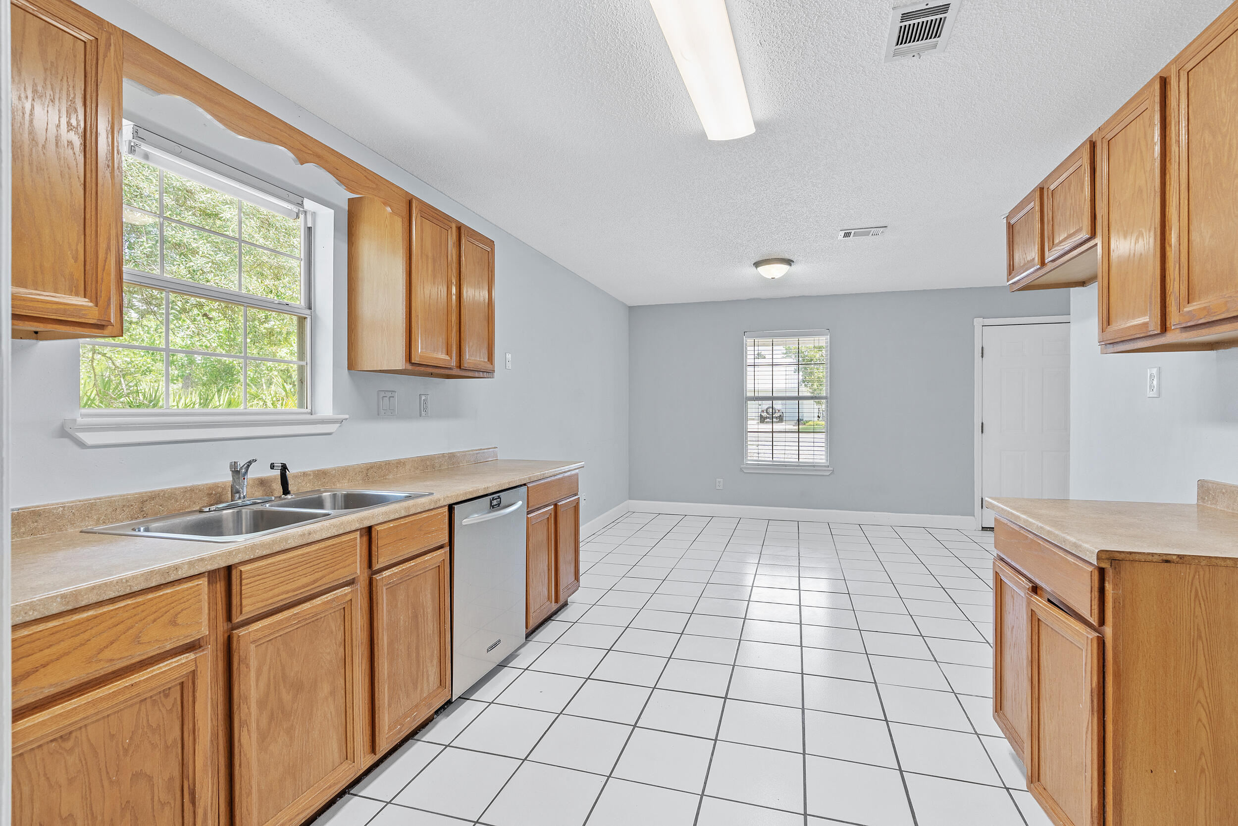 78 Walnut Street Santa Rosa Beach, FL 32459 - Photo 10 of 34 a kitchen with a sink a window and cabinets