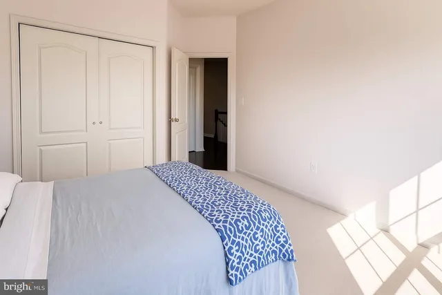 a bedroom with a bed and a mirror