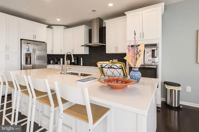 a kitchen with stainless steel appliances kitchen island granite countertop a sink and cabinets