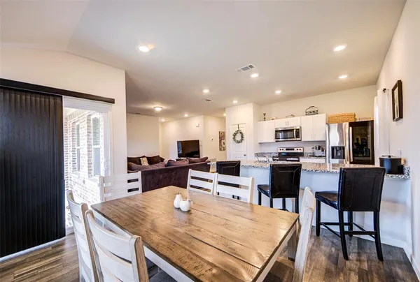 a large kitchen with a table and chairs