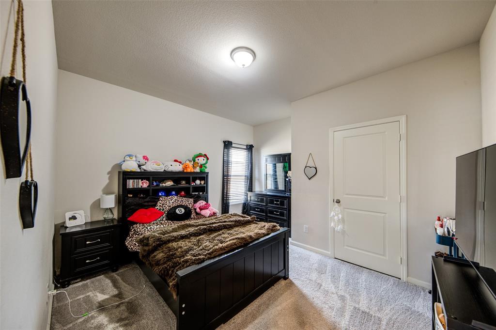 905 Avagail Avenue Springtown, TX 76082 - Photo 8 of 26 Bedroom featuring light carpet and baseboards