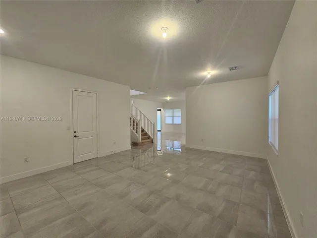 a bathroom with a granite countertop sink a toilet and mirror