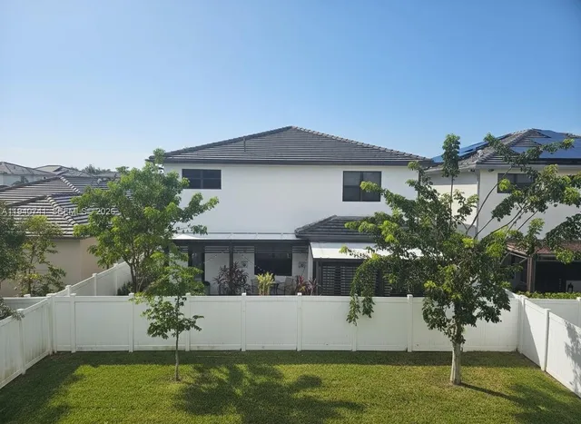 a view of house with garden space and swimming pool