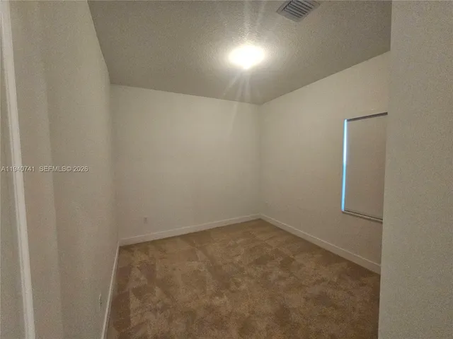 a view of an empty room with a bathroom