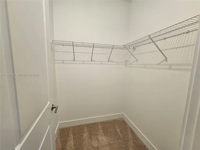 an empty room with windows and entrance