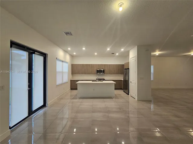 a swimming pool with a large window and kitchen view
