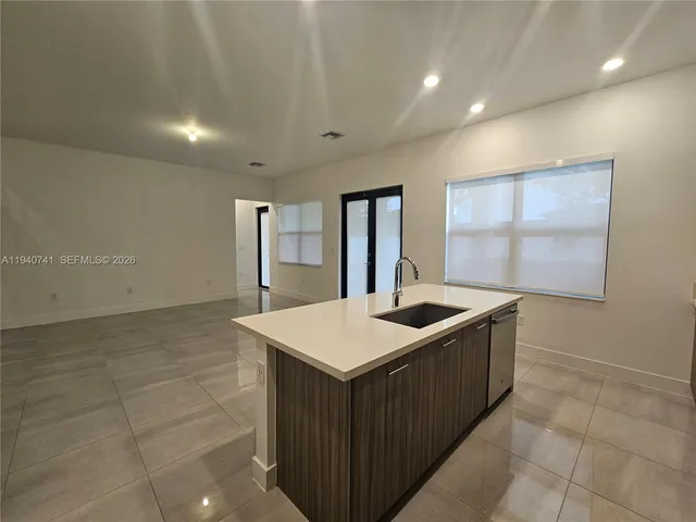 a kitchen with stainless steel appliances granite countertop a sink and a stove