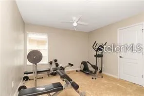 a room with gym equipment and view of bathroom