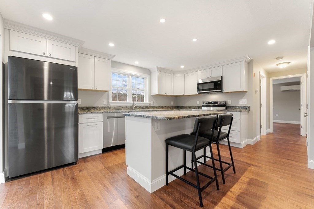 1069 Main Street Dunstable, MA 01827 - Photo 11 of 41 a kitchen with stainless steel appliances granite countertop a refrigerator a stove a sink and a microwave